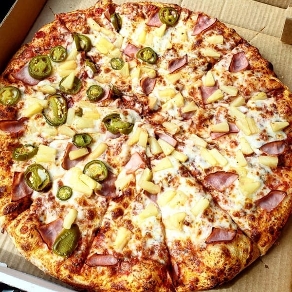 Jack's Pizza & Subs pizza with ham, pineapple, and jalapeños in a cardboard box.