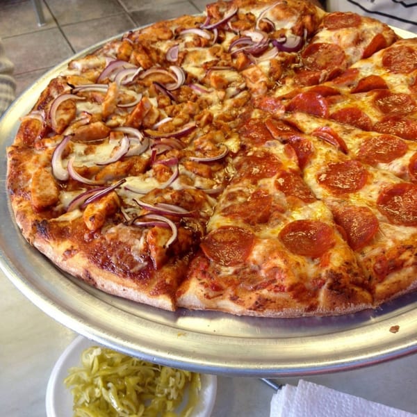 A large pizza from Jack's Pizza & Subs, half pepperoni and half chicken with red onions.