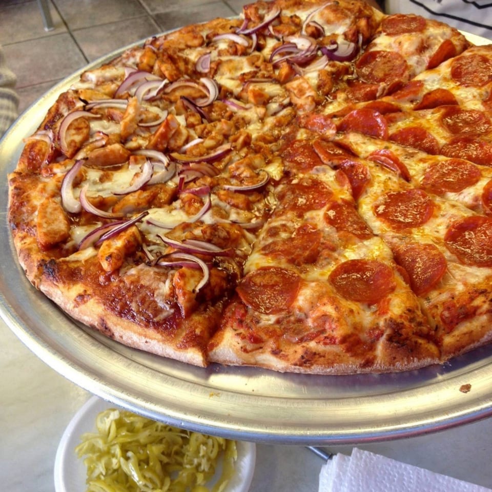A large pizza from Jack's Pizza & Subs, half pepperoni and half chicken with red onions.
